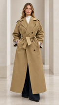 Front full-length view of woman wearing camel maxi trench coat with tie belt