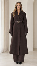 Front view of model wearing chocolate brown belted maxi coat with matching wide-leg pants