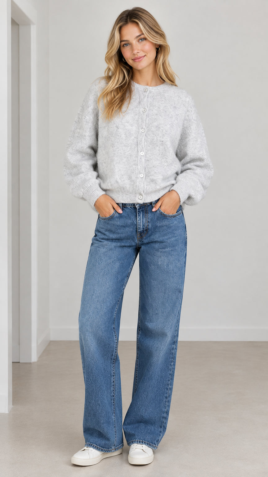 Front full view of woman wearing Light Grey fuzzy knit cardigan with wide-leg jeans