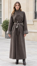 Full-length front view of model wearing charcoal high neck belted maxi coat