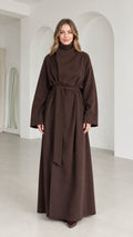 Full front view of model wearing brown high neck belted maxi coat