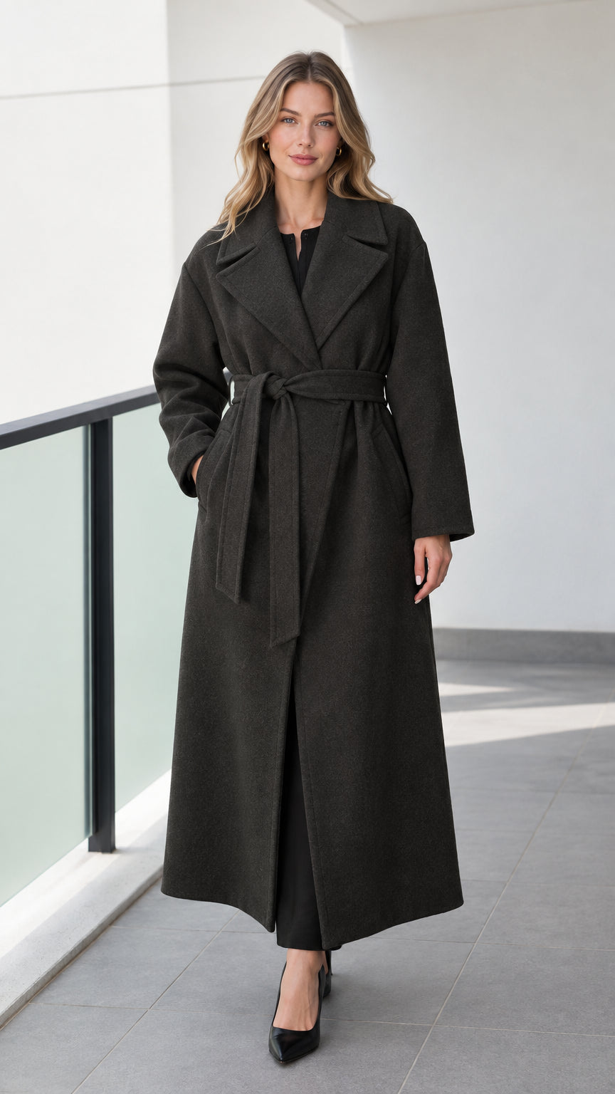 Front view of model wearing a full-length dark grey belted maxi wrap coat