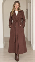 Full front view of women's long brown maxi trench coat tied at the waist
