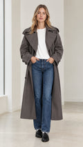 Front full-length view of model wearing charcoal grey oversized maxi trench coat over white tee and jeans