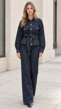 Full front view of model wearing dark blue belted denim jacket and matching wide-leg trousers