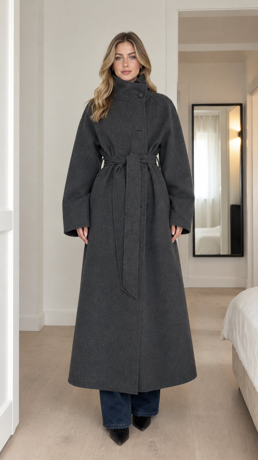 Front full-length view of model wearing charcoal high-neck belted maxi coat