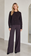 Front full view of model wearing Dark Plum knit button-down cardigan and matching wide-leg trousers