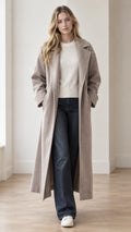 Front view of model wearing full-length taupe wool-look overcoat open over white sweater and denim