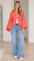 Front view of model wearing coral textured bell sleeve cardigan with wide leg jeans