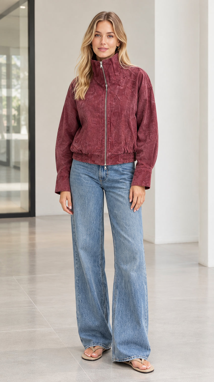 Front full view of woman wearing burgundy corduroy stand collar zip-up bomber jacket with wide-leg jeans