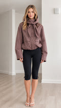 Front full-length view of model wearing dusty rose plaid hooded tie-neck jacket with cropped black leggings