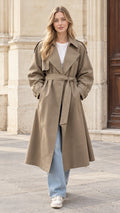 Front full view of a woman wearing a khaki longline belted trench coat over jeans