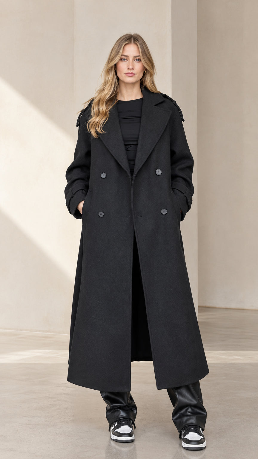 Front full-length view of woman wearing Black double-breasted maxi trench coat
