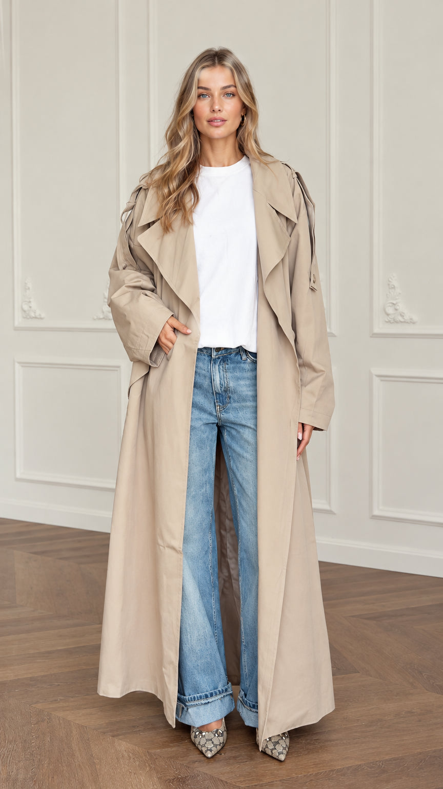 Front full view of woman wearing oversized beige maxi trench coat with white top and jeans