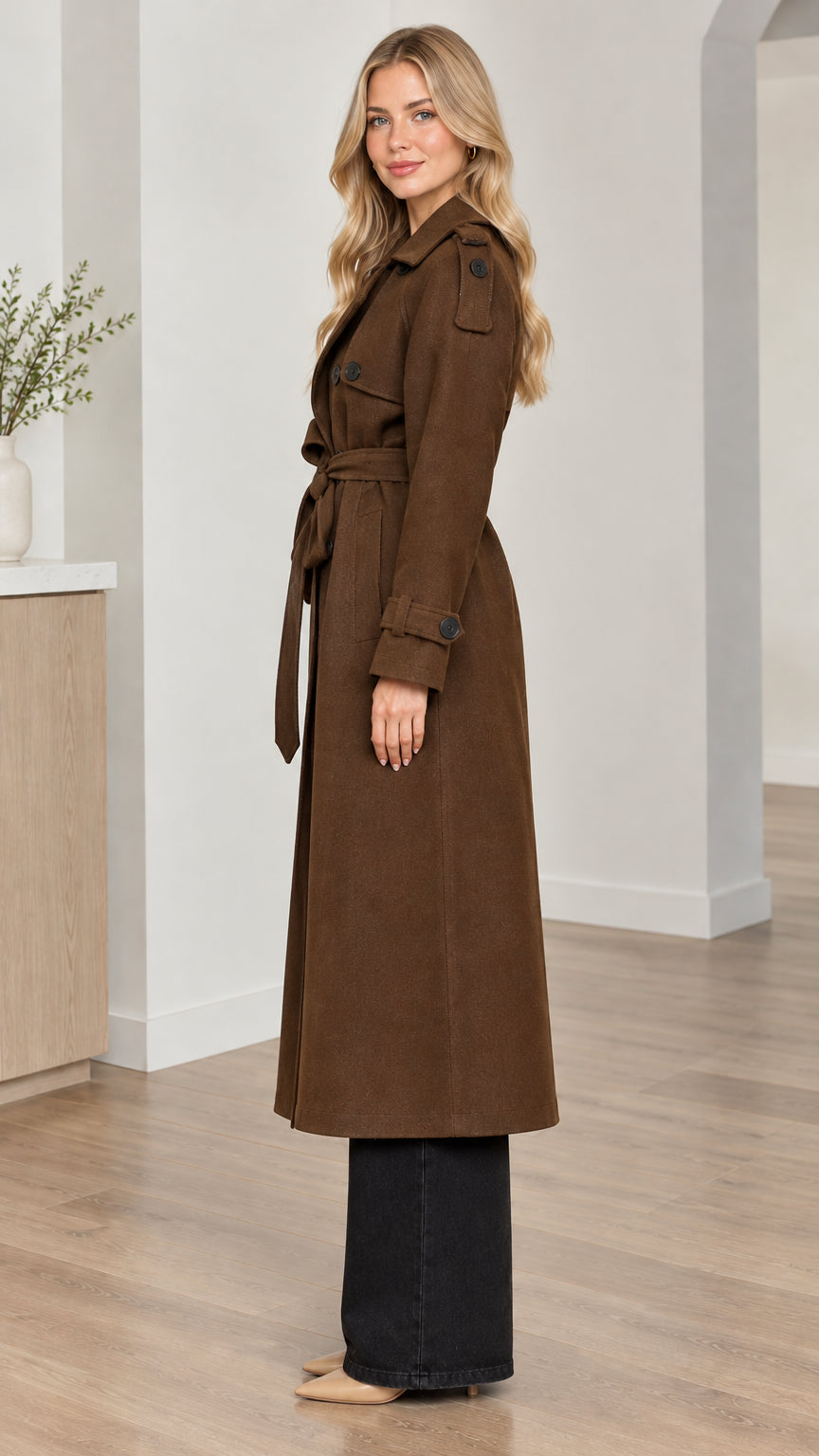 Side profile view of woman modeling the brown long trench coat with belt