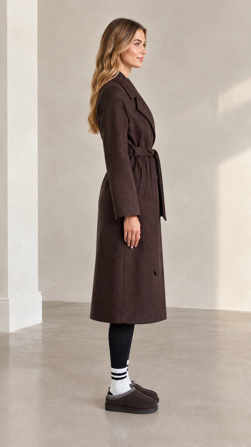 Side full view of woman wearing brown longline belted coat