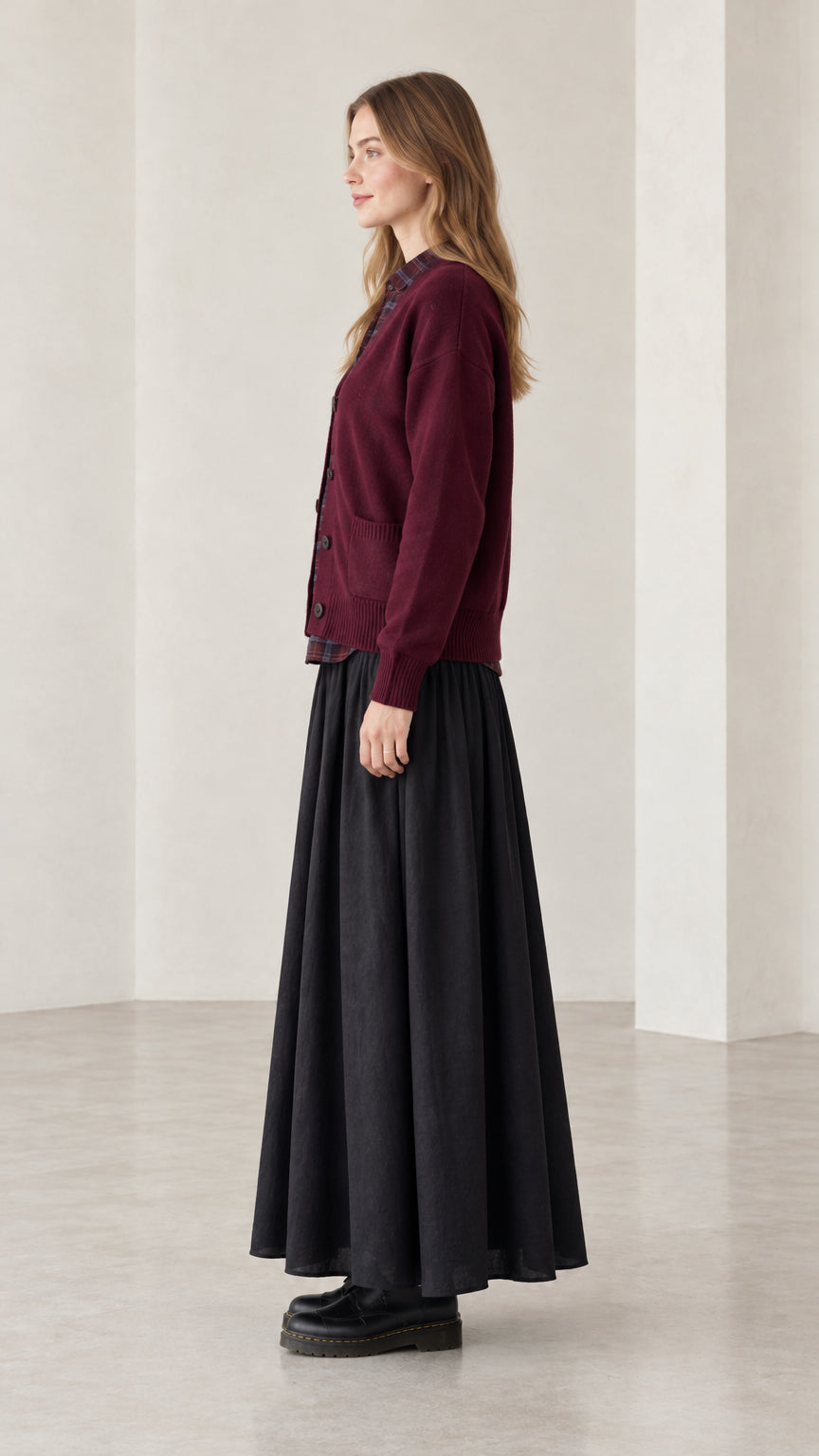 Side profile of woman wearing burgundy button-down knit cardigan sweater