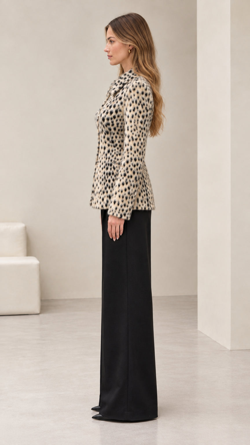Side profile view of woman wearing cream textured animal print button-down jacket