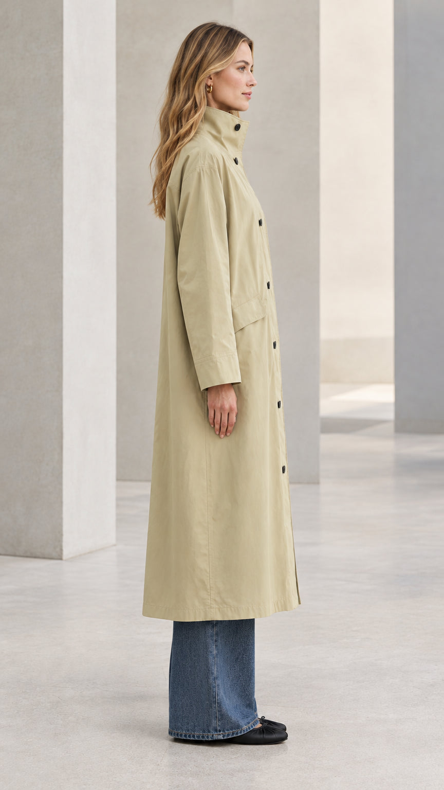 Side profile view of model showcasing the straight drape of the Khaki longline trench coat