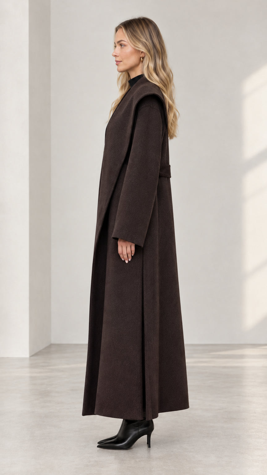 Side profile of woman in dark brown belted longline coat