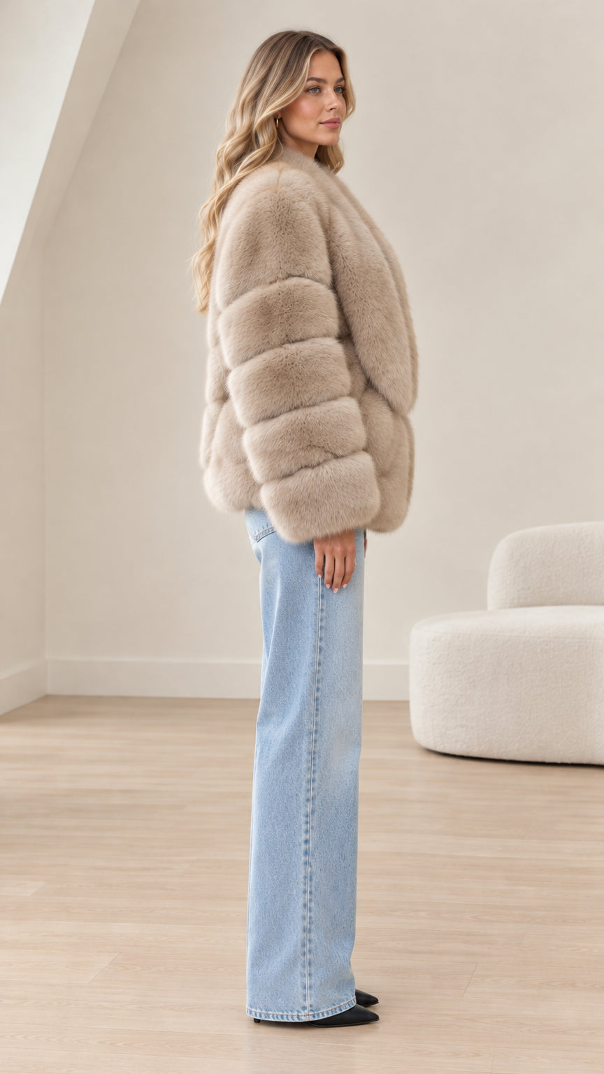 Side profile of model wearing taupe faux fur paneled jacket with wide shawl collar