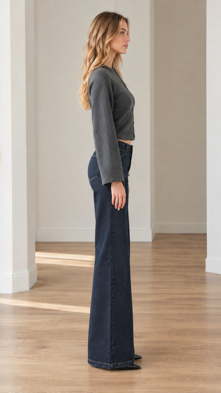 Side profile of model wearing charcoal grey cropped cardigan showing relaxed wide sleeve design