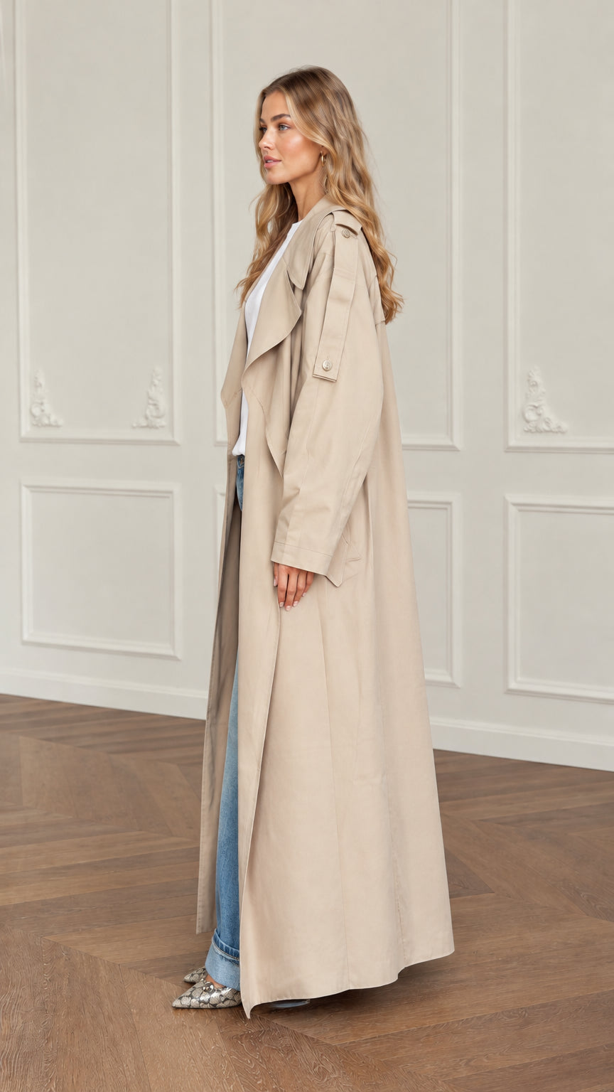Side profile view of woman wearing longline beige duster trench coat