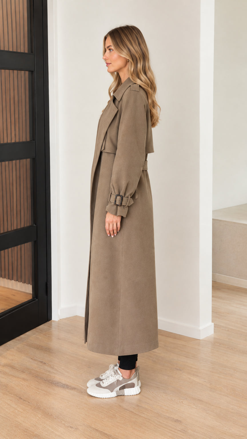 Side profile view of model wearing taupe maxi trench coat
