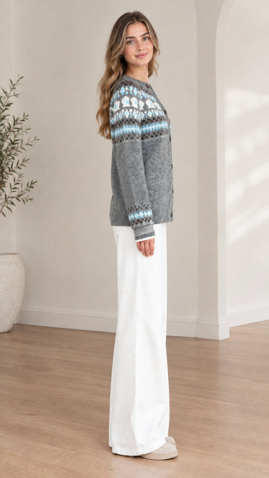 Side profile view of model wearing a grey Fair Isle knit cardigan sweater