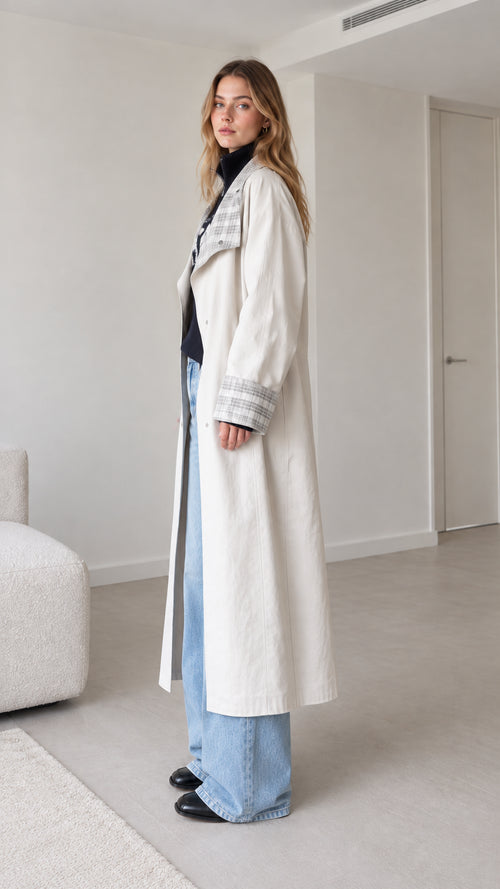 Side profile view of woman wearing off-white longline duster trench coat
