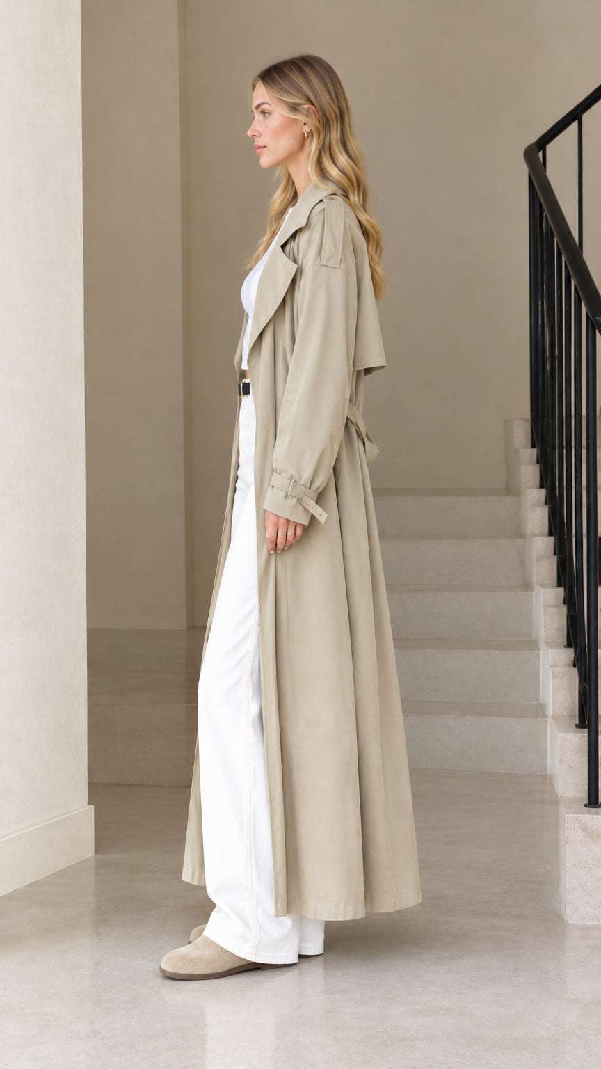 Side profile of model wearing the Khaki maxi trench coat showcasing full length and drape