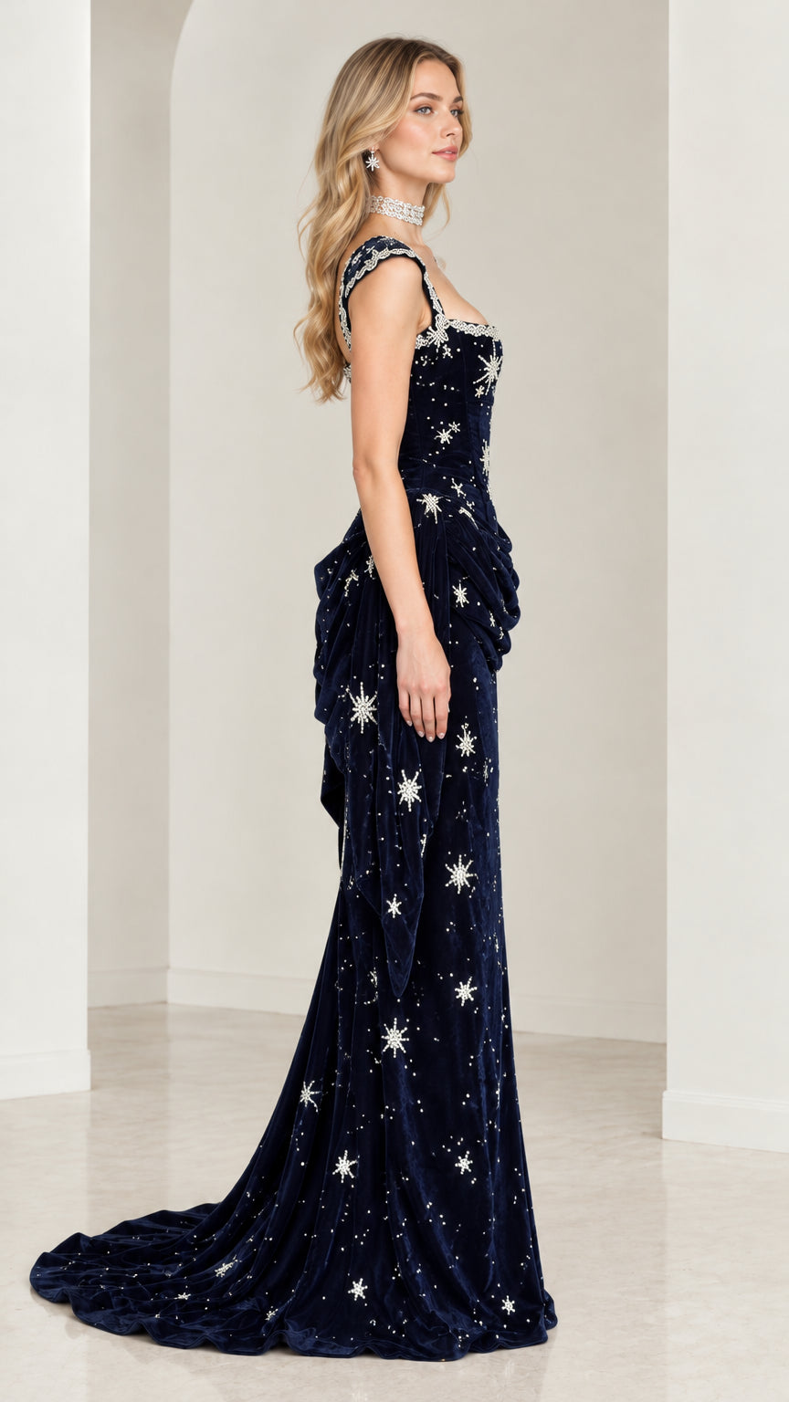 Side profile of model in Navy Blue velvet formal gown showing draped waist detailing and train