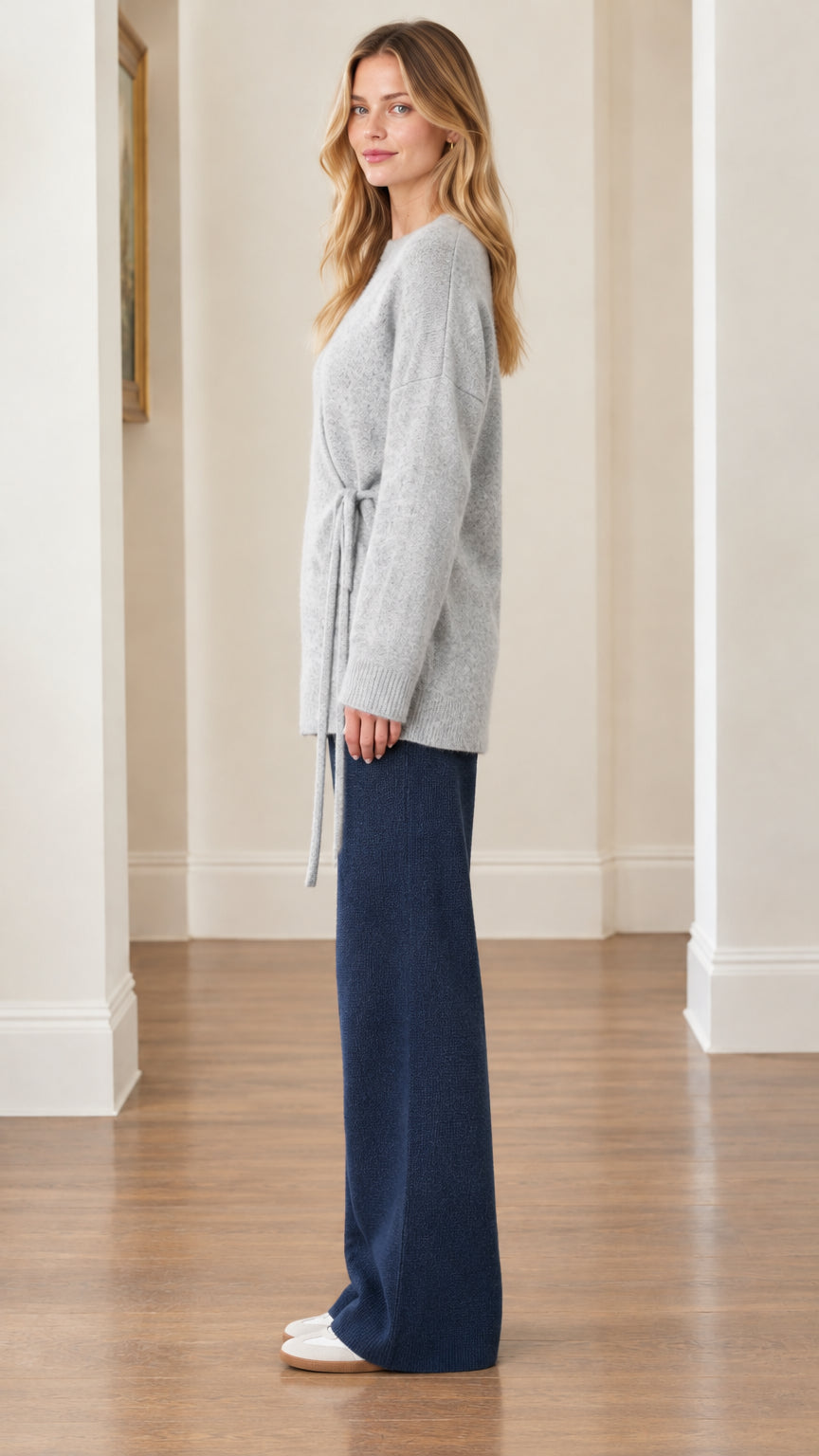 Side profile view of woman wearing Light Gray side-tie tunic knit top