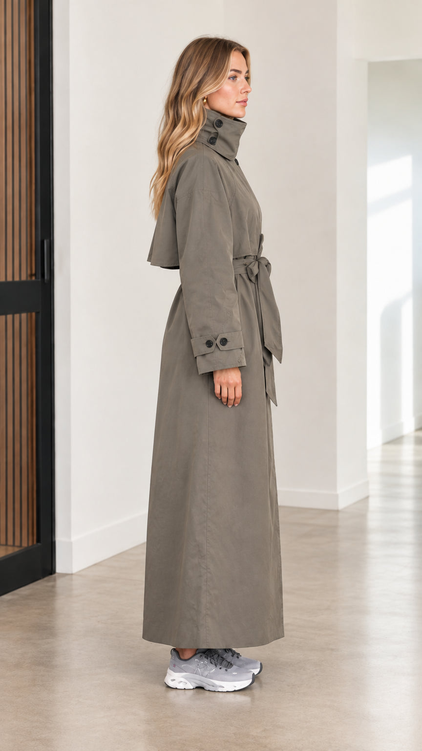 Side profile of women's olive green long belted duster coat