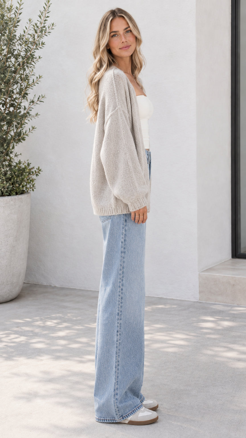 Side view of oatmeal open front knit cardigan showing relaxed fit and sleeve volume