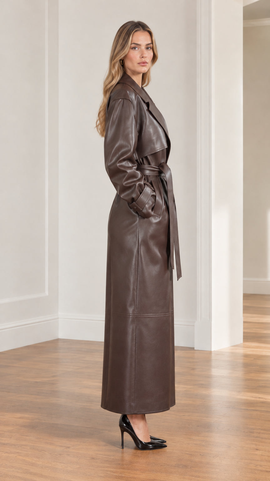 Side profile view of full-length brown faux leather trench coat