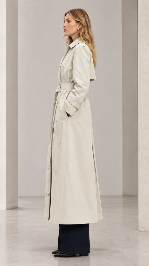 Side profile view of woman wearing Light Beige long belted trench coat