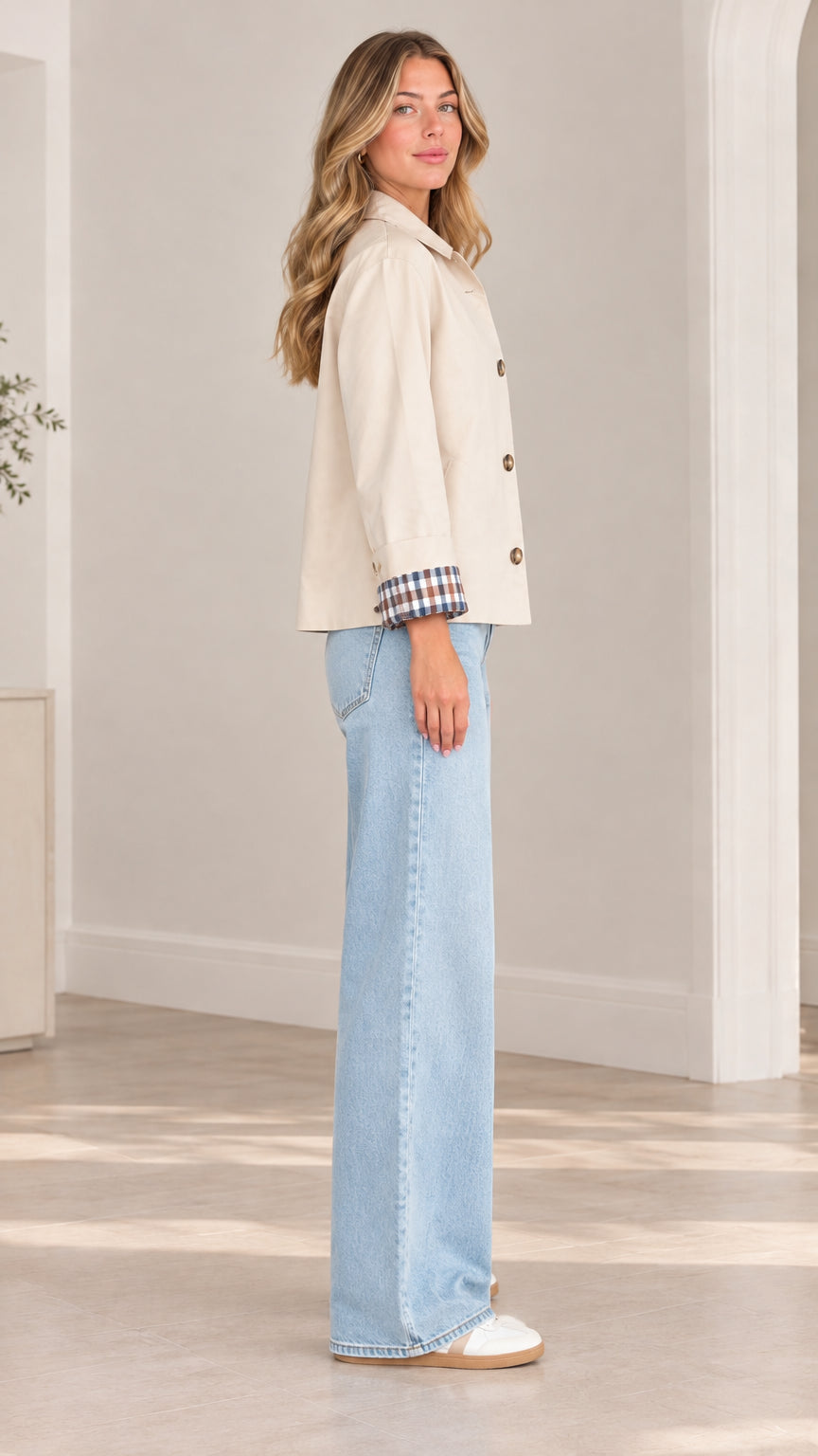 Side full-length view of model wearing beige casual collared jacket with contrast plaid cuff trim