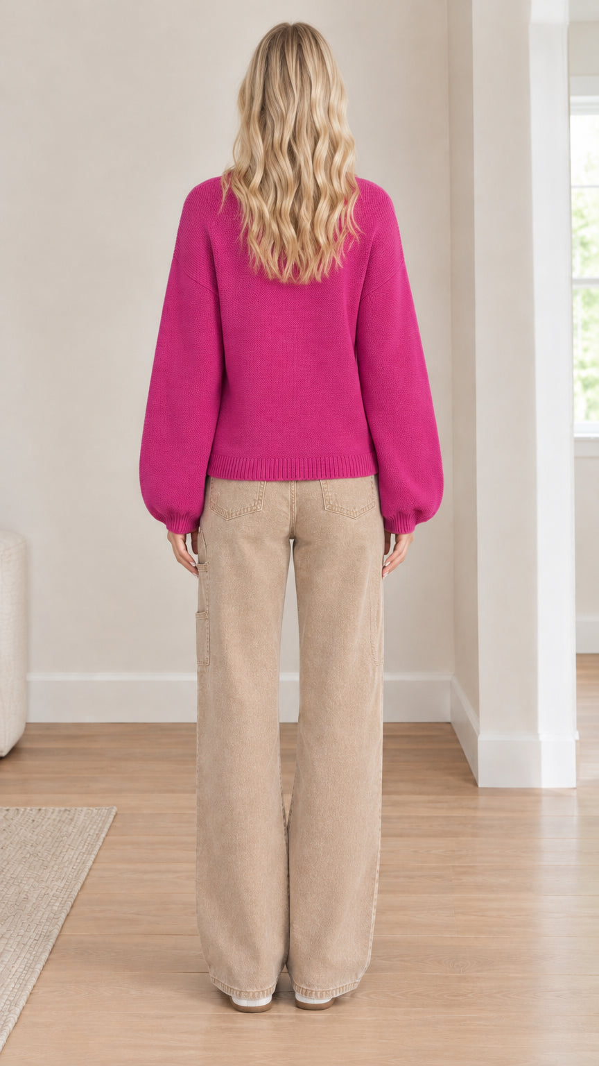 Back full-length view of model wearing fuchsia relaxed knit cardigan