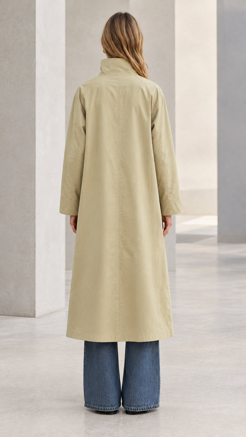 Back full-length view of model wearing the long Khaki stand-collar trench coat