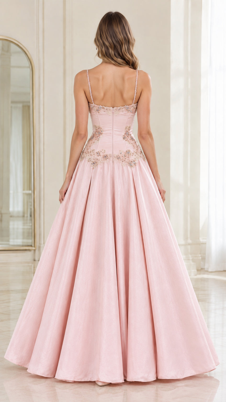 Back view of model in Blush Pink spaghetti strap ball gown with pleated skirt