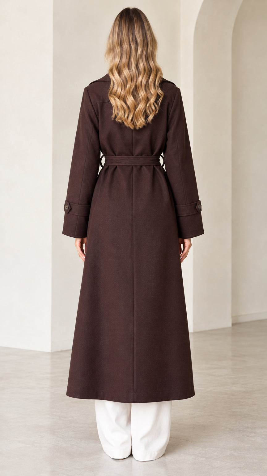 Back full view of dark brown longline coat showing straight hem and waist belt