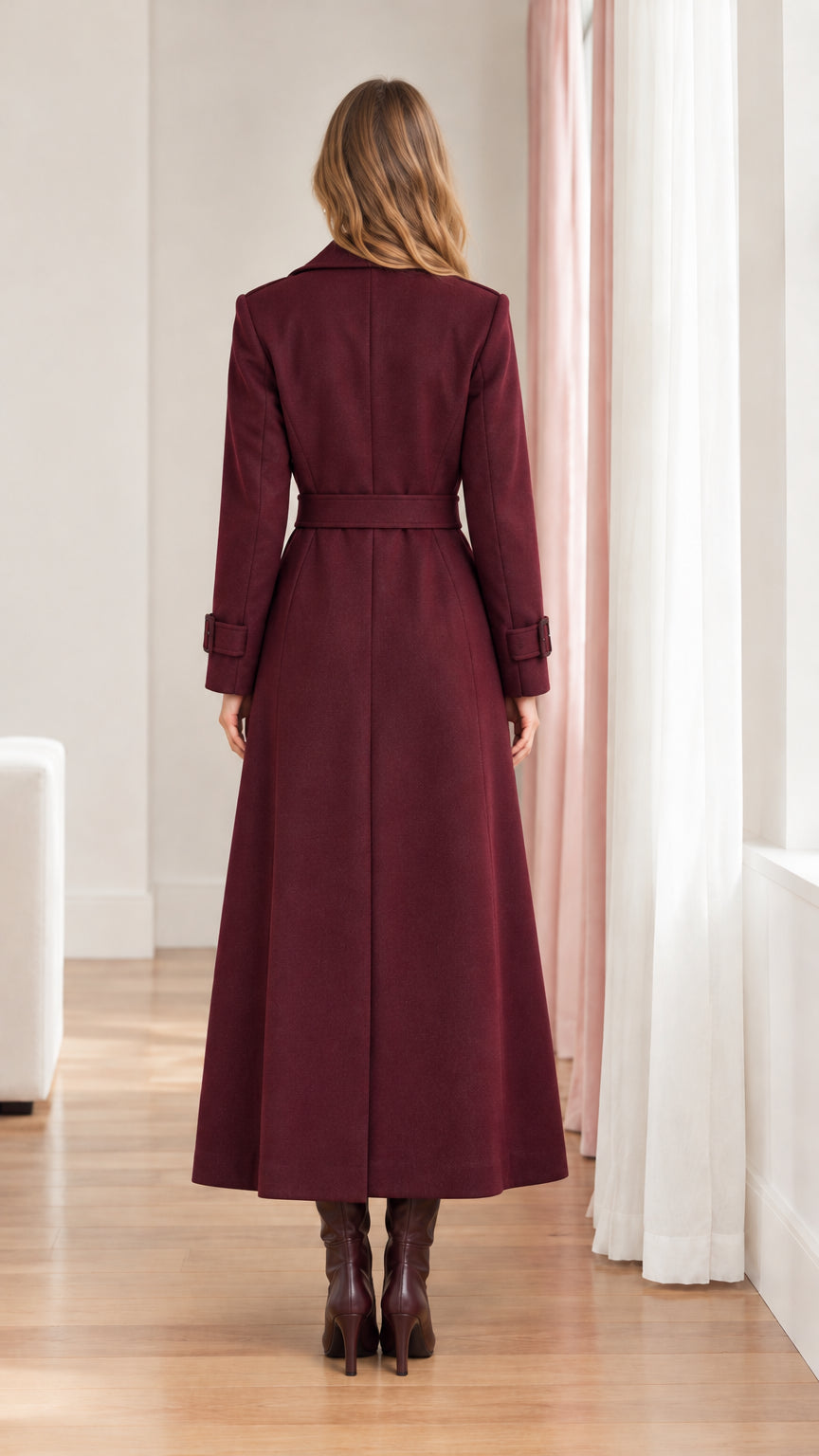 Rear view of woman wearing burgundy tailored maxi trench overcoat