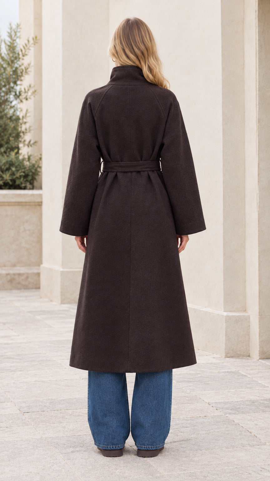 Back full-length view of woman wearing the dark brown belted overcoat