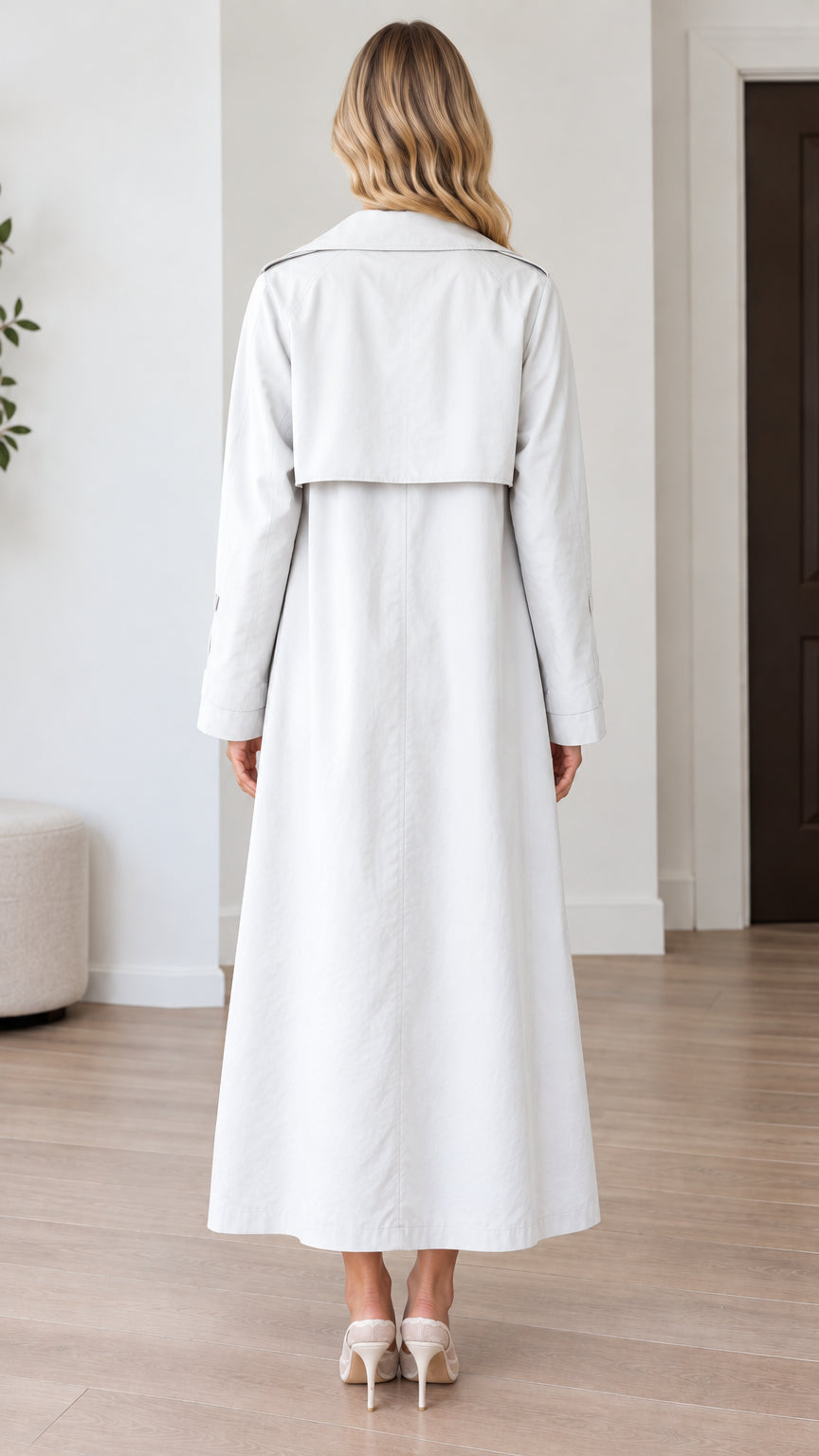 Back view of light grey maxi trench coat showing classic storm flap detail
