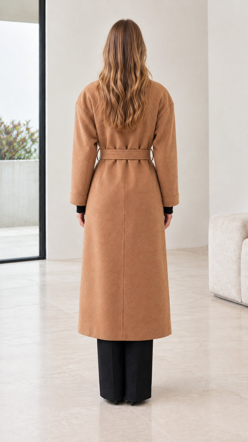 Back view of model wearing the tailored camel long coat