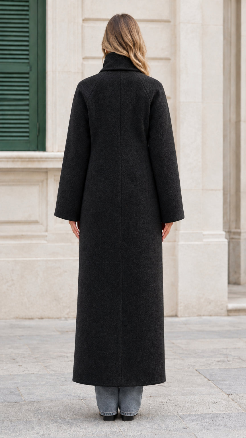Back view of the black longline maxi overcoat showing clean tailoring