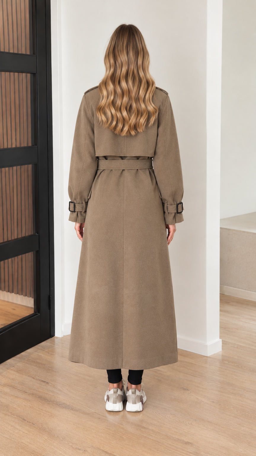 Back view of model wearing taupe longline duster coat with storm flap