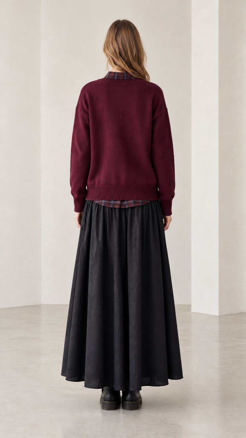 Back view of woman wearing burgundy knit cardigan sweater