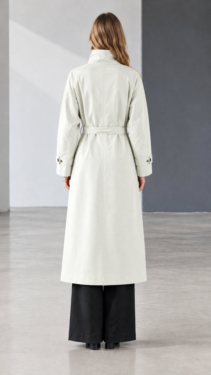 Back view of model wearing off white belted longline trench coat